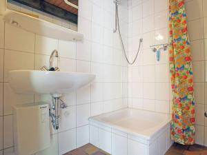 a white bathroom with a sink and a shower at Ferienhaus mit herrlicher Aussicht in Schmallenberg