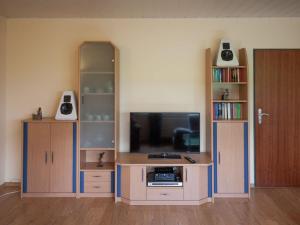 a living room with a entertainment center with a tv at Enchanting Holiday Home in B defeld with Terrace in Schmallenberg