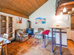 a room with a table and chairs and a fireplace at Ferienhaus mit herrlicher Aussicht in Schmallenberg +27 photos