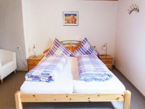 a bedroom with a wooden bed with pillows on it at Pleasant Apartment in Ernst bei Cochem with Garden in Ernst