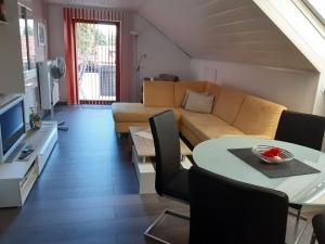 a living room with a couch and a table at Apartment in Kniebis with garden seating area in Kniebis