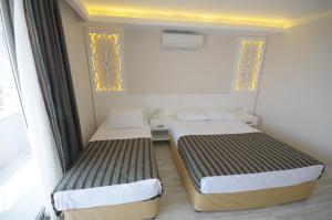Postel nebo postele na pokoji v ubytování Aura Boutique Hotel