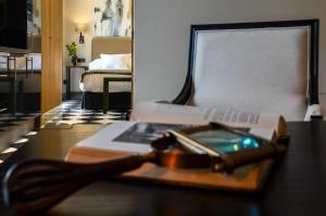 a table with a book and a remote control on it at Aguilas5 SevillaSuites in Seville