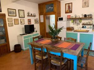 a kitchen with a table with chairs and a refrigerator at Casa Tasso in Reggello