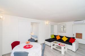 a living room with a couch and a table at Apartment Jasmin in Dubrovnik