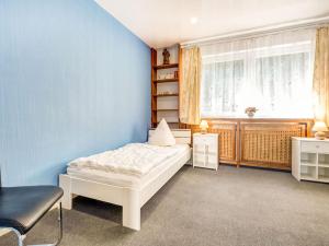 a bedroom with a white bed and a window at Ferienhaus in Medebach nahe Skigebiet in Medebach