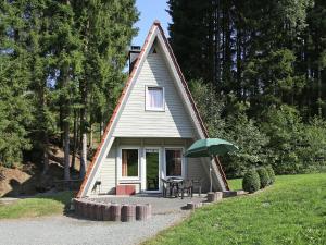 シュマレンベルクにあるMagnific Holiday Home in Untervalme near Ski Areaの小屋(テーブル、緑の傘付)