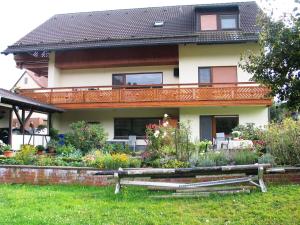 a house with a garden in front of it at Apartment in the Odenwald with terrace in Mossautal