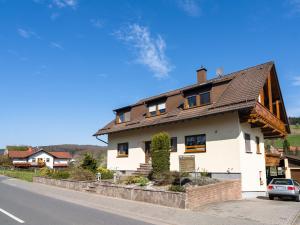 a white house with a brown roof at Apartment in the Odenwald with terrace in Mossautal