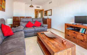 a living room with a couch and a tv at Casares Del Sol in Casares