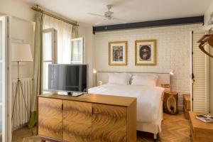 a bedroom with a bed and a flat screen tv at Pera Neuf in Istanbul