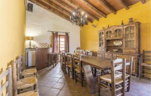 a kitchen and dining room with a wooden table and chairs at Stunning Home In Almachar With House A Mountain View in Almáchar