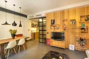 a living room with a dining table and a television at Pera Neuf in Istanbul