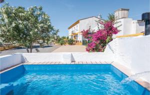 a swimming pool in front of a house at 6 Bedroom Beautiful Home In Huelva in Huelva