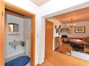a room with a bathroom with a sink and a table at Flat in Bayerisch Eisenstein with garden in Bayerisch Eisenstein