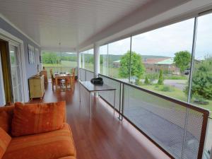 a room with a balcony with a couch and a table at Luxurious Holiday Home in T nnesberg with Garden in Tännesberg