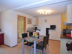 a kitchen and dining room with a table and chairs at Apartment in Lechbruck Bavaria with garden in Lechbruck