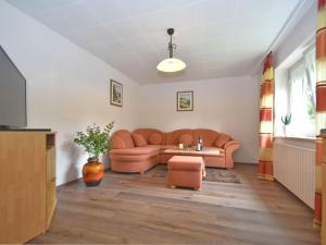 a living room with a couch and a table at Cozy Holiday Home in Schiefweg with Garden in Waldkirchen