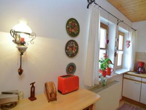 a kitchen with a table with a red box on it at Flat with sauna in the Bavarian Forest in Waldkirchen