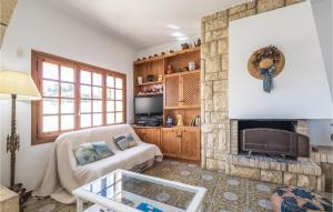 a living room with a fireplace and a couch at Roc De San Gaiet in Comarruga