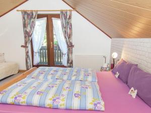 a large bed in a room with a large window at holiday home with sauna Thuringian Forest in Neuhaus am Rennweg