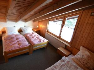 a room with two beds and a window at Relaxing holiday home in Deilingen with terrace in Deilingen