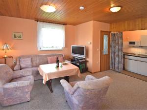 a living room with a couch and chairs and a table at Holiday home near the Schwarza Valley in Grossbreitenbach