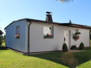 a small white house with flowers in the window at Modern Holiday Home in Schwarzhausen Near Forest in Schwarzhausen