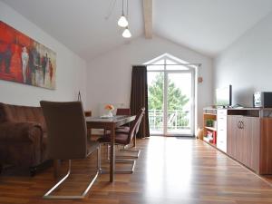 a dining room with a table and chairs and a window at Beautiful Apartment in Willingen with a Balcony in Willingen