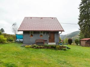 a small house in a field of grass at Holiday home in Altenfeld with private terrace in Altenfeld