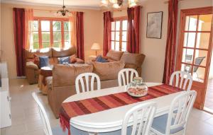 a living room with a couch and a table and chairs at Stunning Home In Sa Coma With 3 Bedrooms And Outdoor Swimming Pool in Sa Coma