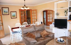 a living room with a couch and a table at Stunning Home In Sa Coma With 3 Bedrooms And Outdoor Swimming Pool in Sa Coma