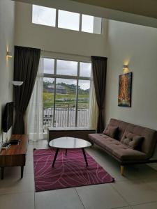 a living room with a couch and a table at W3WarmStay@GoldenHills/3RPenthouse/WiFi/PasarMalam/2carpark in Brinchang