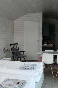 a bedroom with a bed and a table and chairs at Willa Rauha G in Lumijoki