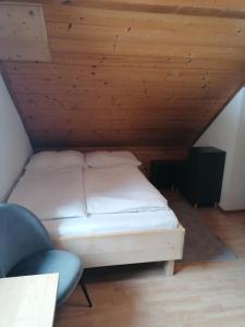 Cama en habitación con techo de madera en Gasthof Rettenbachalm en Bad Ischl