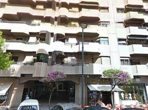 a large white building with flowers in front of it at Pensión La Castellana in Logroño