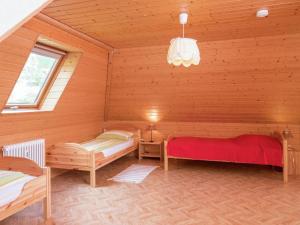 a room with two beds in a wooden cabin at Beautiful farmhouse near the ski area in Buchenbach