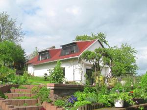 una casa con techo rojo y jardín en Holiday home near forest in Fischbach, en Emsetal