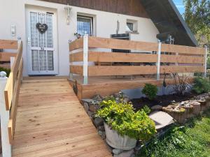 a wooden walkway leading up to a house at Beautiful apartment near the lake in Herrischried