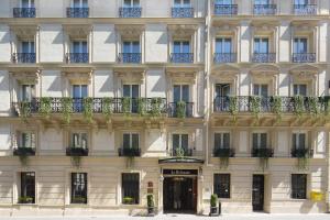 a facade of a building with windows and balconies at Le Belmont Paris in Paris