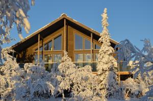 a log home covered in snow at Villa Castillo in Saariselka
