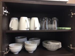a shelf filled with bowls and plates and glasses at Maison Ota Building A Building B - Vacation STAY 11139 in Takamatsu