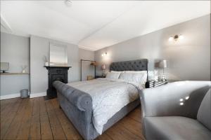 a bedroom with a large bed and a couch at Private Room with En-suite, City Centre With Free On Site Parking in Hereford