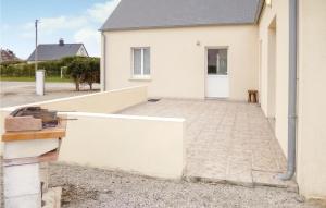 a white house with a porch and a driveway at Gorgeous Home In St Marcouf De L'isle in Saint-Marcouf