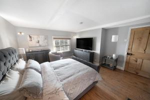 a bedroom with a bed and a couch and a television at Private Room with En-suite, City Centre With Free On Site Parking in Hereford