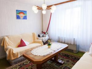 a living room with a couch and a coffee table at Enjoy a holiday on the farm in a quiet area in Sellerich