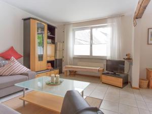 a living room with a couch and a table at Comfortable holiday home Manderscheid with garden in Manderscheid