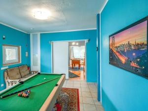a living room with a pool table and blue walls at Madfeld Apartment Retreat in Brilon