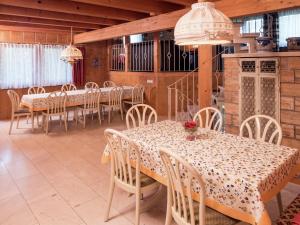 una sala da pranzo con tavoli, sedie e lampadari a braccio di Holiday home in Lossburg near the ski area a Lossburg
