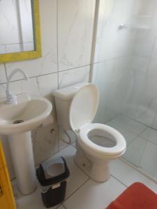 a bathroom with a toilet and a sink at Pousada Atlântica stay home in Tramandaí +51 photos